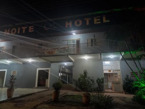 a hotel at night with a neon sign on it at Noite hotel in Palmas