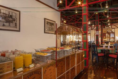 a buffet line with food on display in a restaurant at Heritance Tea Factory in Nuwara Eliya