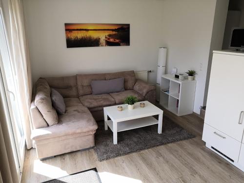 a living room with a couch and a table at Haus Lackner in Timmendorfer Strand