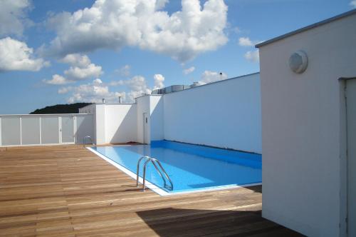 a swimming pool on the roof of a building at Promenada Gwiazd by Baltic Home in Międzyzdroje