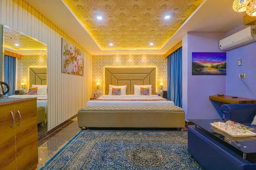 a bedroom with a king sized bed and a bathroom at FabHotel Prime Z Grand in Ludhiana