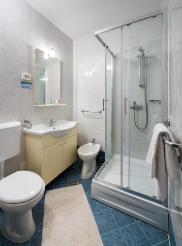a bathroom with a toilet sink and a shower at Adriatic Apartment in Skiper Resort in Savudrija