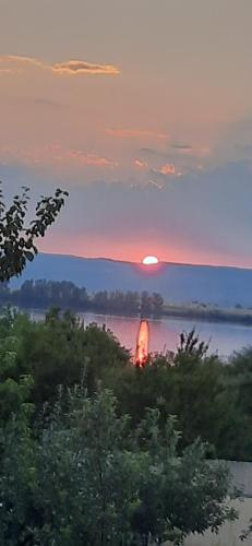 a sunset over a body of water with a train at Laguna Verde in Crivina