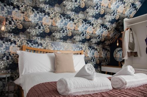 a bedroom with a bed with a floral wallpaper at Croft4 in Broadford