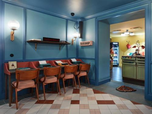 a dining room with blue walls and a table with chairs at 25hours Hotel Indre By in Copenhagen