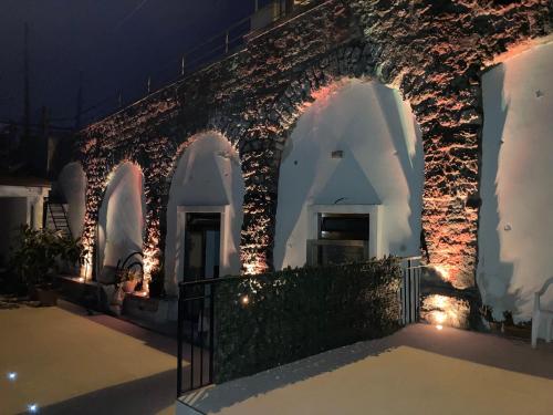 a building with lights on it at night at Apartaments B&M in Ischia