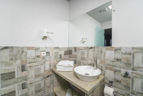 a bathroom with a sink and a mirror at Ianos Hotel in Lefkada Town