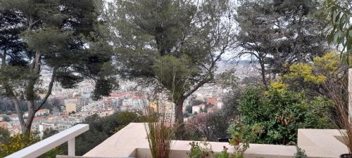 a view of a city with trees and buildings at Chambre d hôte avec clim terrasse et petit déjeuner Hauteurs de Nice in Nice