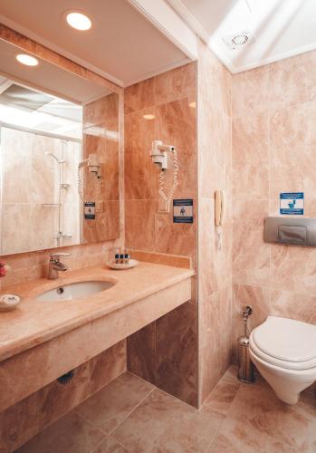 a bathroom with a sink and a toilet at Royal Atlantis Beach in Side