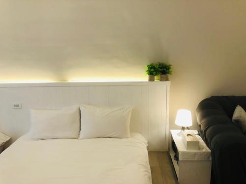 Postel nebo postele na pokoji v ubytování 海沐輕旅 Sea Mu Kenting