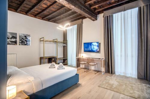 a bedroom with a large bed in a room at Capranica Private Suites in Rome