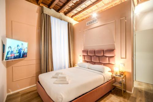 Voodi või voodid majutusasutuse Capranica Private Suites toas