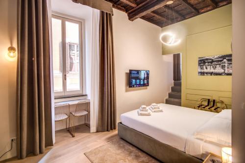 Voodi või voodid majutusasutuse Capranica Private Suites toas
