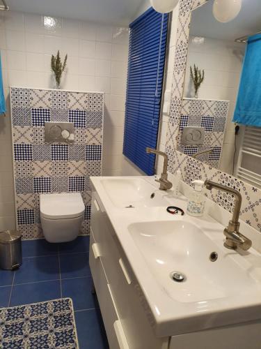 a bathroom with a white sink and a toilet at Baranca Stima in Aldeia de Além