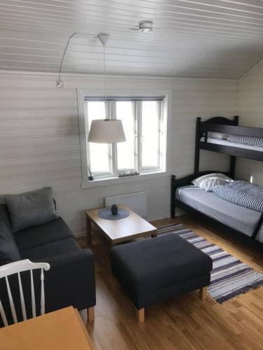 a living room with a couch and a bunk bed at Reinebua in Reine
