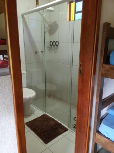 a glass shower in a bathroom with a toilet at POUSADA ESTAÇÃO MARMELO in Queimada