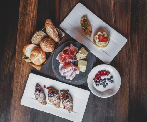a table with a bunch of different types of food at Hotel Genziana in Ortisei