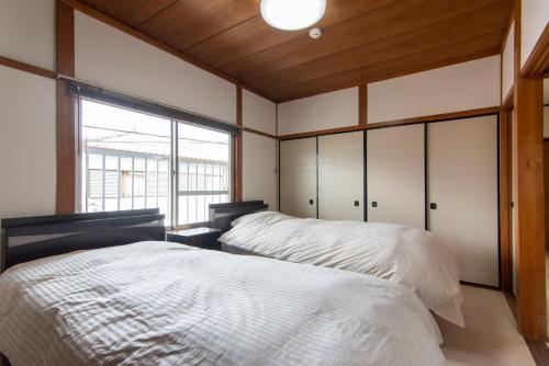 Postel nebo postele na pokoji v ubytování Nara Park Blue Sky
