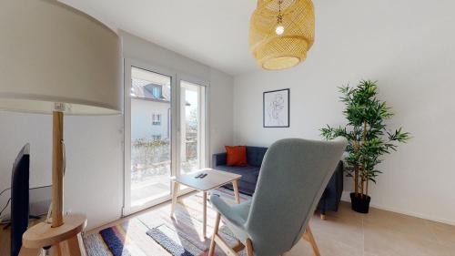 a living room with a couch and a table and a chair at Nice apartments at 10min from Payerne, fully equipped in Vers chez Perrin