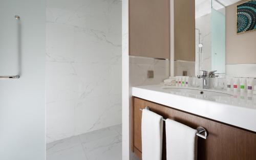 a bathroom with a sink and a mirror at Swissôtel Wellness Resort Alatau Almaty in Almaty