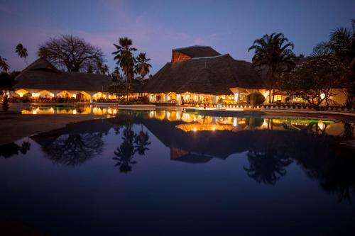 um resort com piscina de água à noite em Zanzibar Beach Resort em Zanzibar City