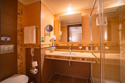 a bathroom with a toilet and a sink and a shower at Royal Atlantis Spa & Resort in Side
