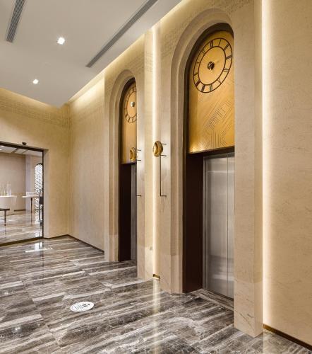 an empty lobby with a clock on the wall at Wanda Vista Istanbul in Istanbul