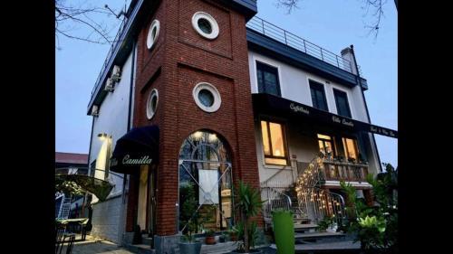 a brick building with a clock tower on it at Villa Camilla Milano in Milan