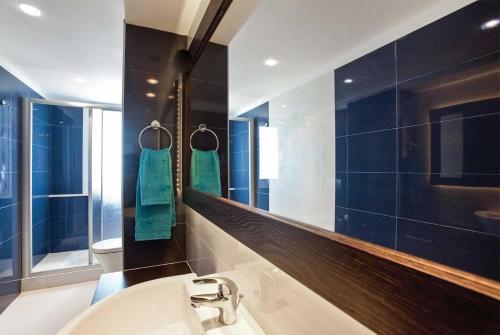 a bathroom with a sink and a mirror at Paradise Beach II in Kiotari