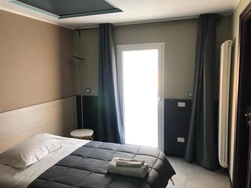 a bedroom with a bed and a large window at Villa Camilla Milano in Milan
