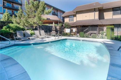 a large swimming pool with chairs and a building at Next to Lake, Pool, 10 Acre Park, 1 Mile to Town, Best Prices in Chelan