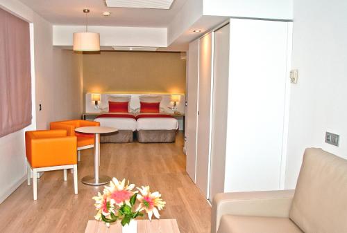 a hotel room with a bed and a table and chairs at BQ Augusta Hotel in Palma de Mallorca