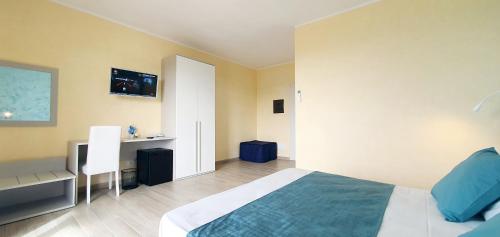 1 dormitorio con cama y escritorio. en I Fichi D'India Rooms en Capo Vaticano