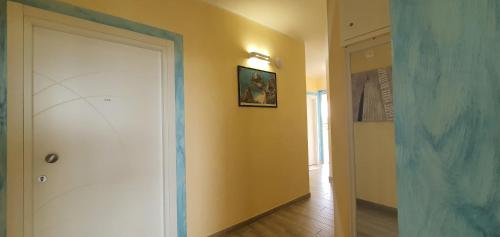 a hallway with a white door in a room at I Fichi D'India Rooms in Capo Vaticano
