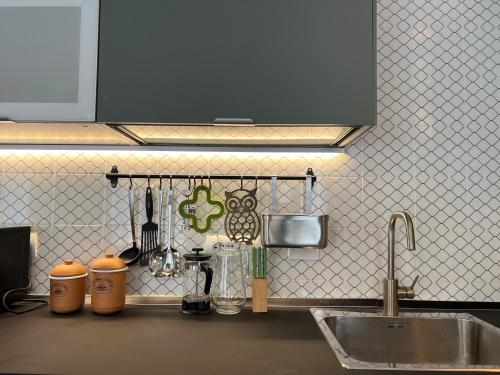 a kitchen with a sink and a counter top at Accanto alla piazza in Bologna