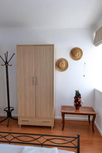 a wooden cabinet in a room with a table at Duka's House in Lukovë