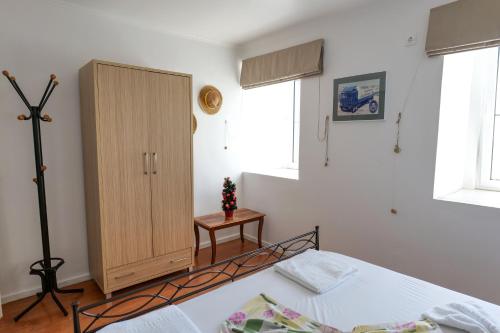 a bedroom with a bed and a cabinet at Duka's House in Lukovë