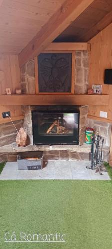 a stone fireplace in a living room with at Romantic Spa in Venas