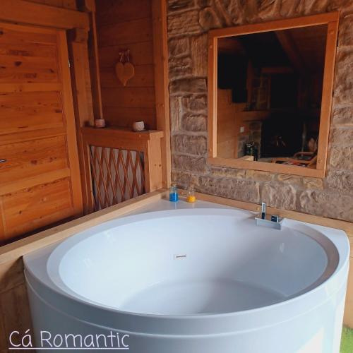 a bath tub in a cabin with a window at Romantic Spa in Venas