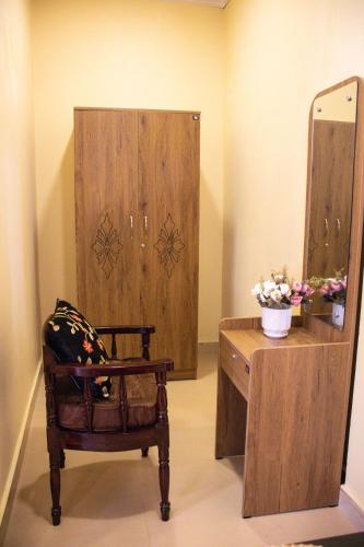 a dressing room with a chair and a mirror at The Arcadia Pool and Villa - Umroi in Shillong