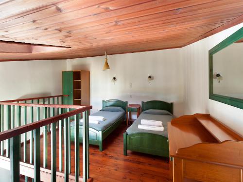 a living room with two beds and a staircase at Alkionides Seaside Hotel in Plataniás