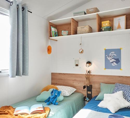 Кровать или кровати в номере Camping L'Occitan