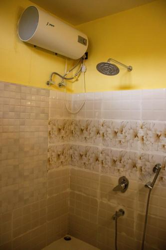a bathroom with a shower and a blow dryer at The Arcadia Pool and Villa - Umroi in Shillong