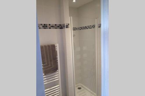 a bathroom with a shower with a glass door at Les Logis du Petit Prince in La Teste-de-Buch