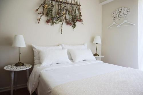 a bedroom with a white bed and two lamps at Casal de São José - Peaceful Country House near Mafra and Lisbon - Garden, Space and Comfort in Mafra
