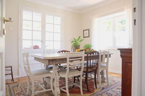 a dining room with a table and chairs at Casal de São José - Peaceful Country House near Mafra and Lisbon - Garden, Space and Comfort in Mafra