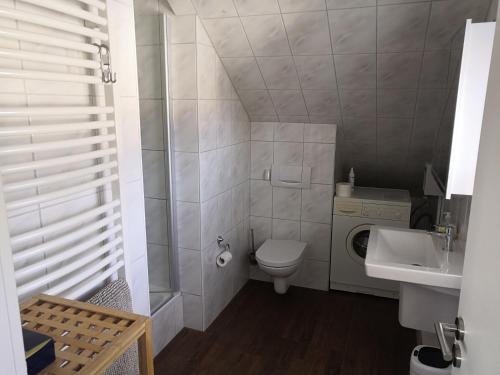 a small bathroom with a toilet and a sink at Haus Lackner in Timmendorfer Strand
