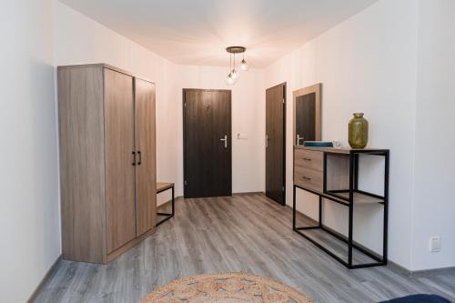 a living room with a dresser and a cabinet at Hotel Do Poduchy in Zawiercie
