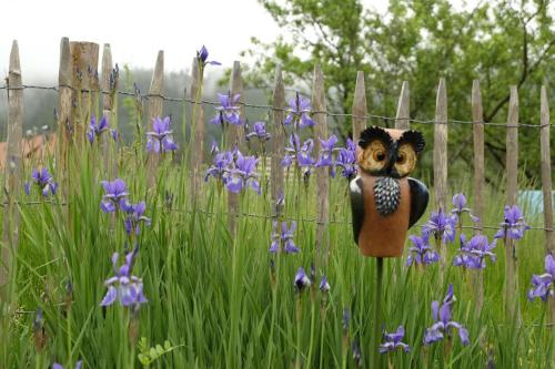 a statue of a cheetah standing in a field of purple flowers at SchwarzWild - Ferienwohnung und Ferienzimmer in Baiersbronn