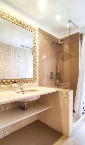 a bathroom with a sink and a mirror at Corazón Cangues VUT2306AS in Cangas de Onís